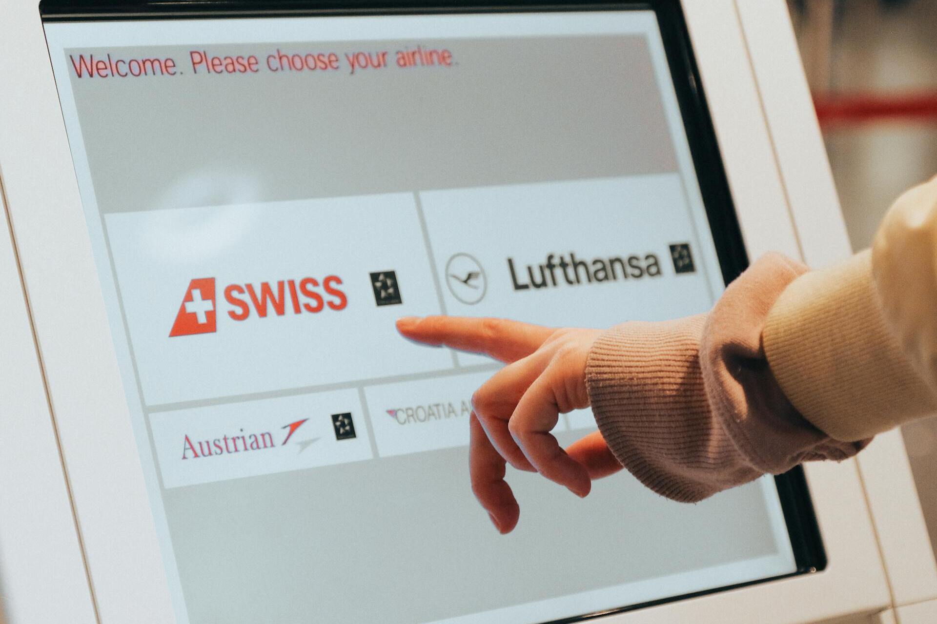 A person choosing an airline on a screen