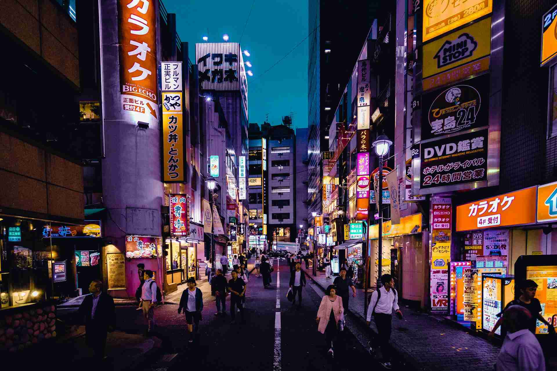 People walking on the streets of Tokyo surrounded by buildings